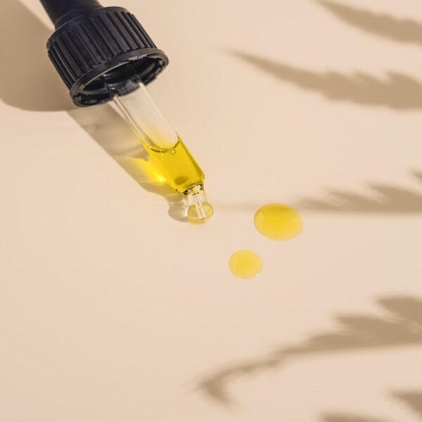 Picture of a oil dropper on a table with black seed oil dripped on the page