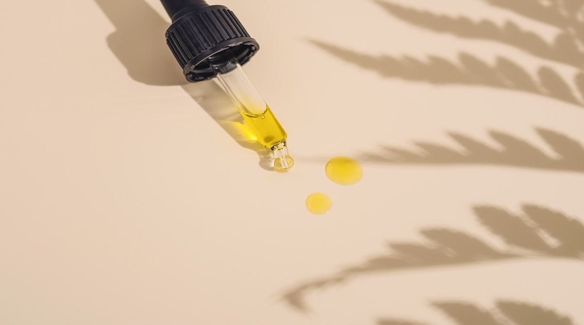 Picture of a oil dropper on a table with black seed oil dripped on the page