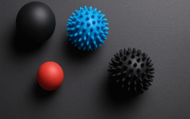 Picture of 4 massage balls against a black background