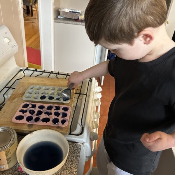 Picture of a toddler making gummies from Nutra Organics gelatin